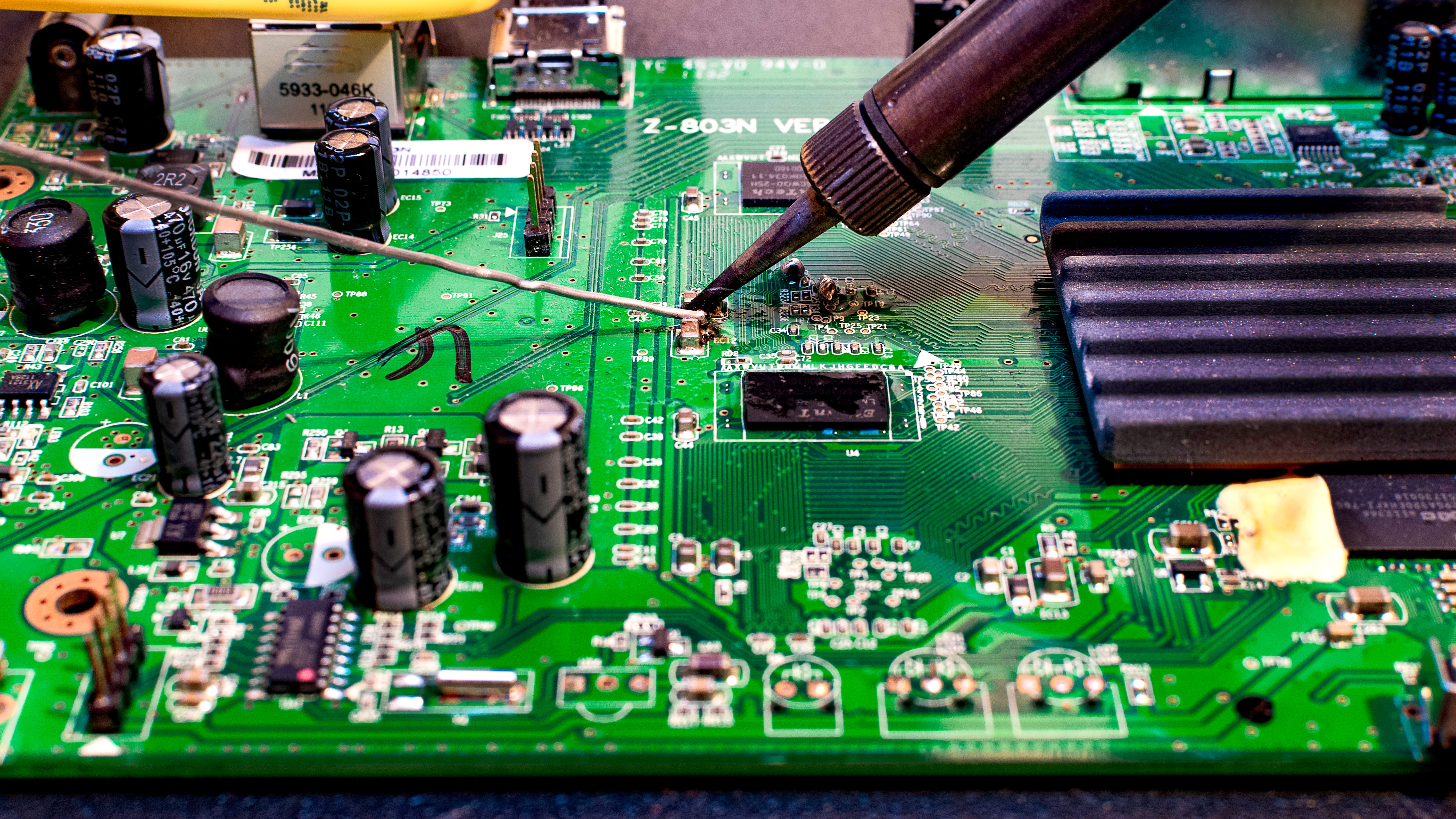 Certified Nathtec technician soldering a TV main board in Gauteng workshop